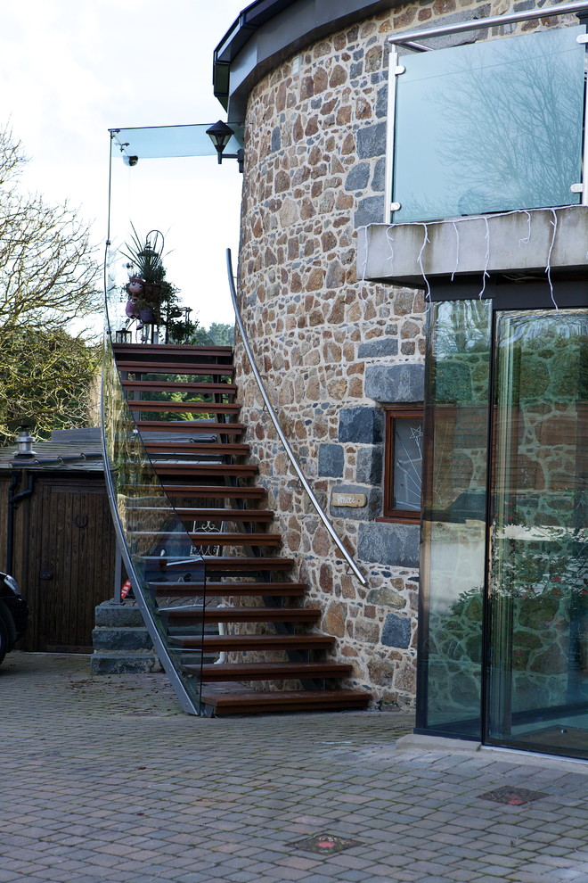 Photo of a contemporary house exterior in Channel Islands with stone cladding.