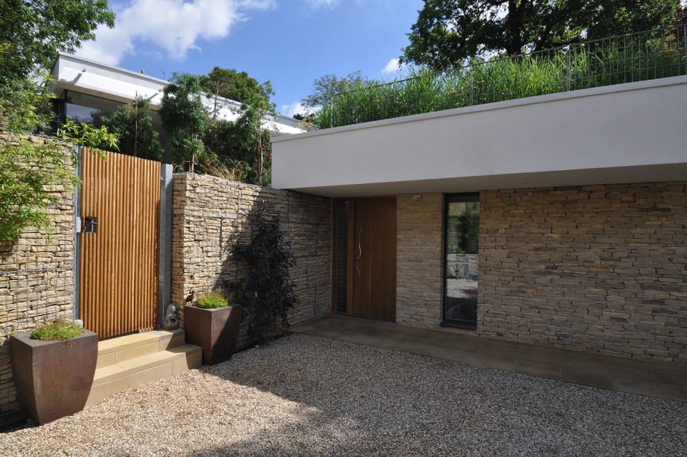 Photo of a medium sized and white contemporary two floor brick house exterior in London.