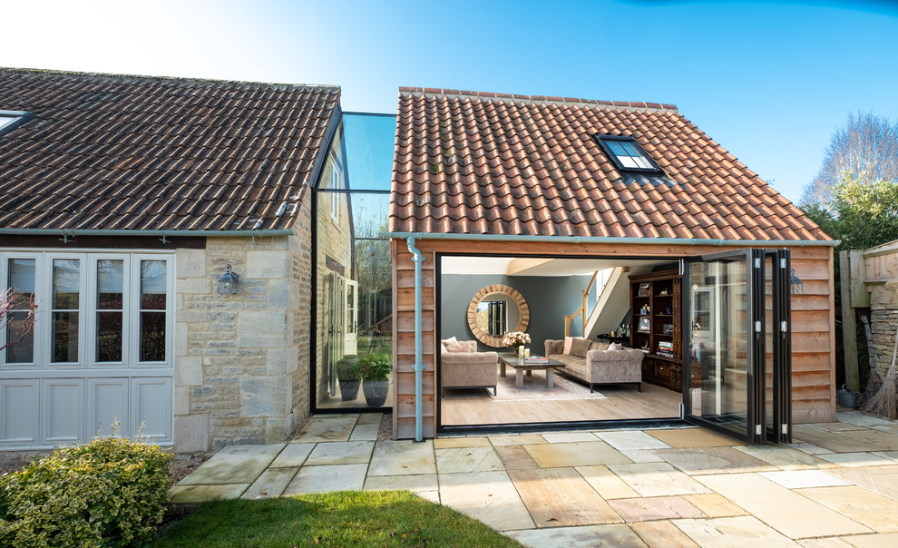 Inspiration for a modern house exterior in Gloucestershire with wood cladding, a pitched roof and a tiled roof.