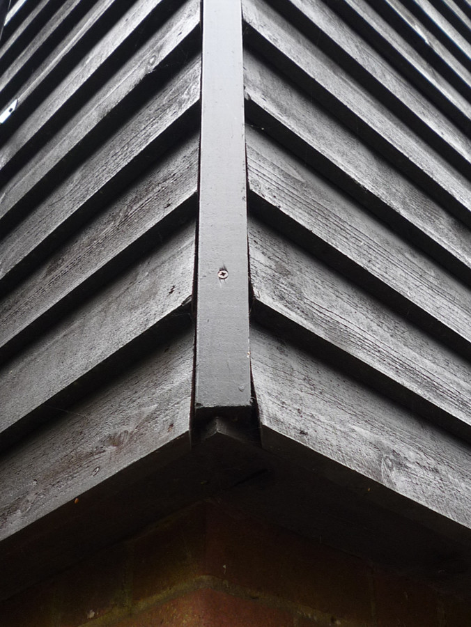 Inspiration for a medium sized and black contemporary two floor house exterior in Surrey with wood cladding.