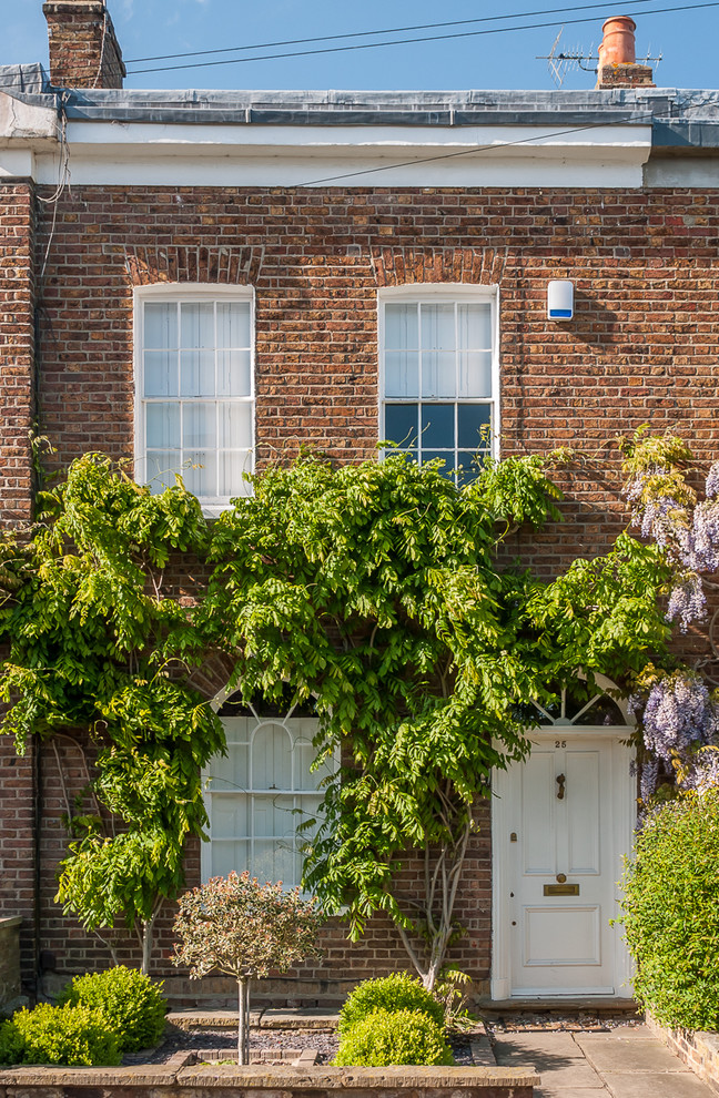 Elegant two-story brick flat roof photo in Surrey
