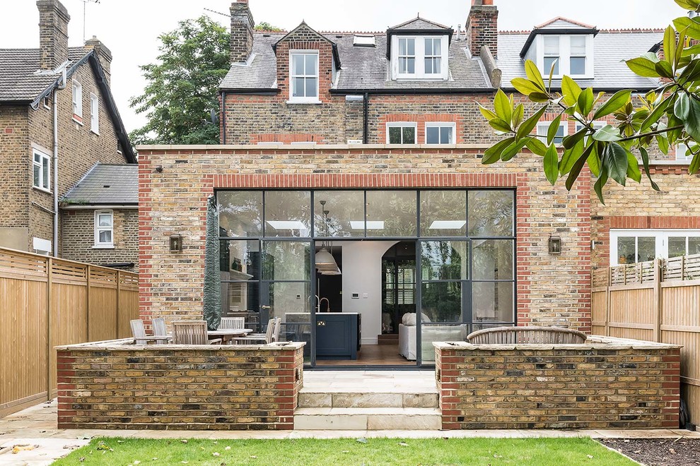 Design ideas for a large traditional two floor brick house exterior in London.