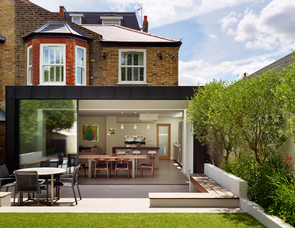 Photo of a brown contemporary brick house exterior in London with three floors.