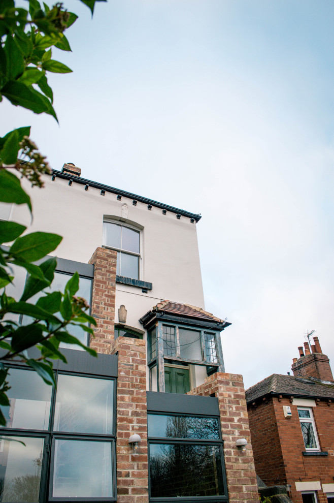 Design ideas for a large and multi-coloured urban brick semi-detached house in Other with three floors, a flat roof and a mixed material roof.