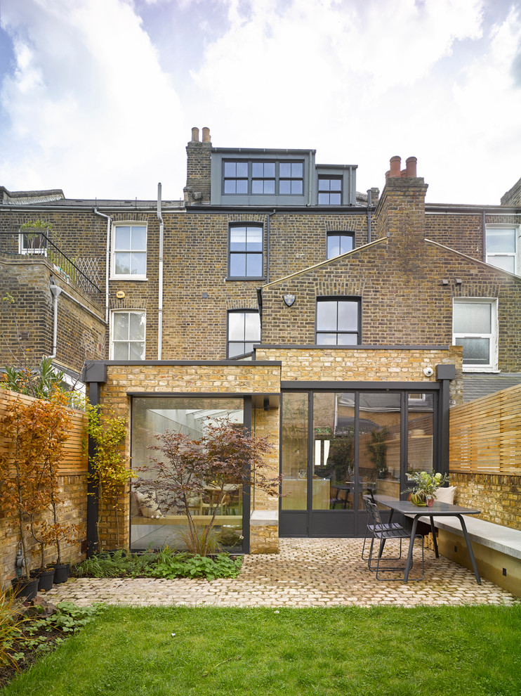 Contemporary brick house exterior in London with three floors.