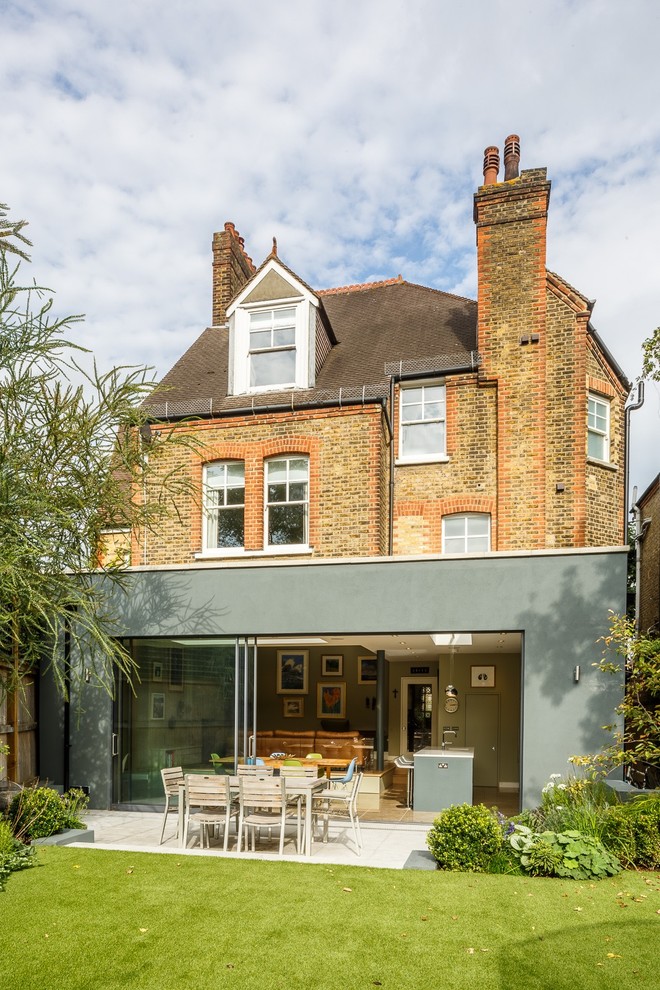 This is an example of a gey contemporary brick and rear extension in London.