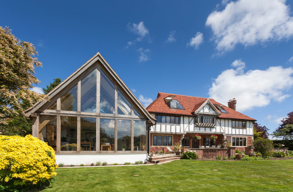 Design ideas for a large and white traditional brick house exterior in Hampshire.