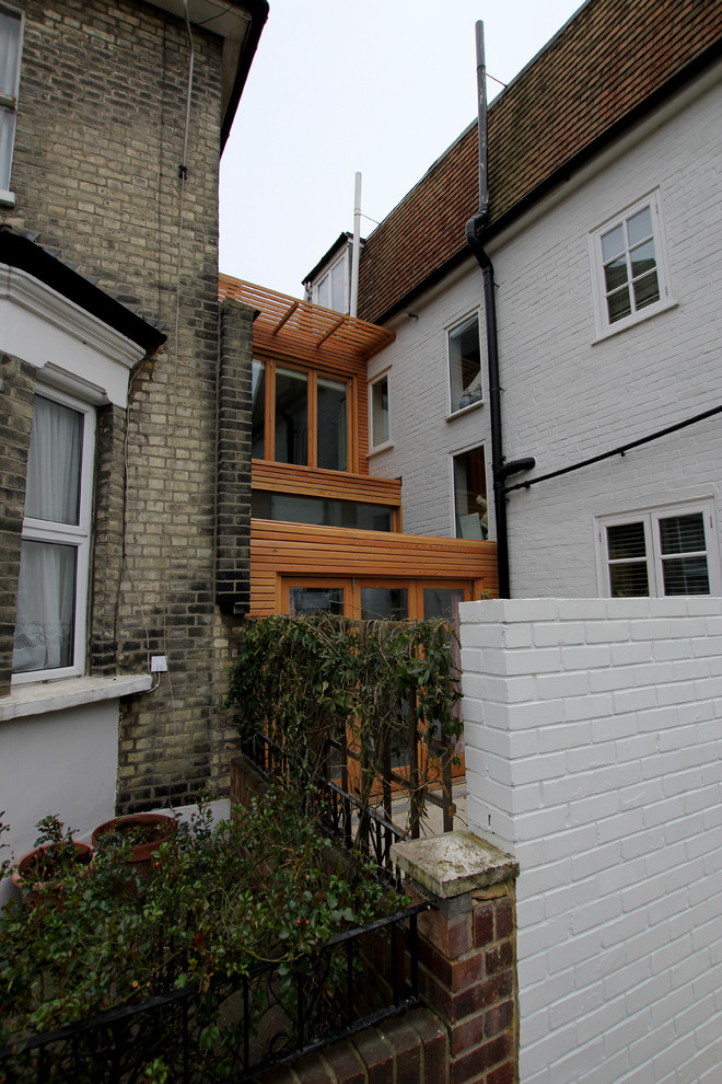 Contemporary two floor house exterior in London with wood cladding.