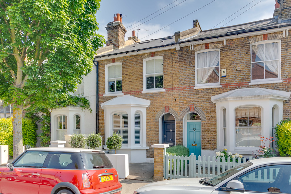 This is an example of a brown classic two floor brick terraced house in London with a pitched roof.