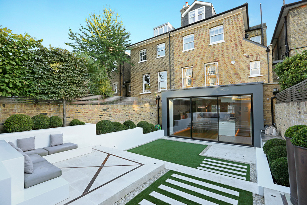 Example of a mid-sized trendy exterior home design in London