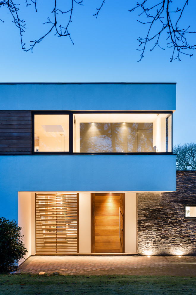 Идея дизайна: двухэтажный дом в современном стиле с комбинированной облицовкой и плоской крышей