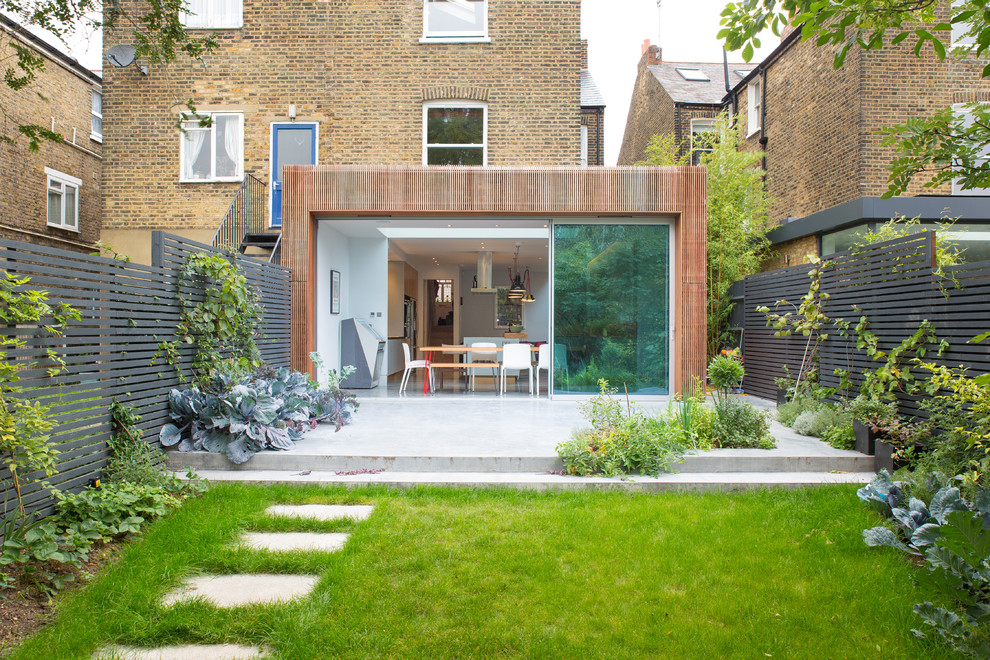 Photo of a modern brick house exterior in London with three floors and a flat roof.