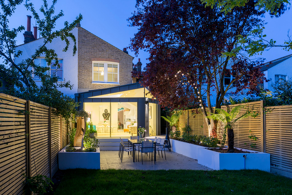 Inspiration for a medium sized contemporary brick semi-detached house in London with a lean-to roof.