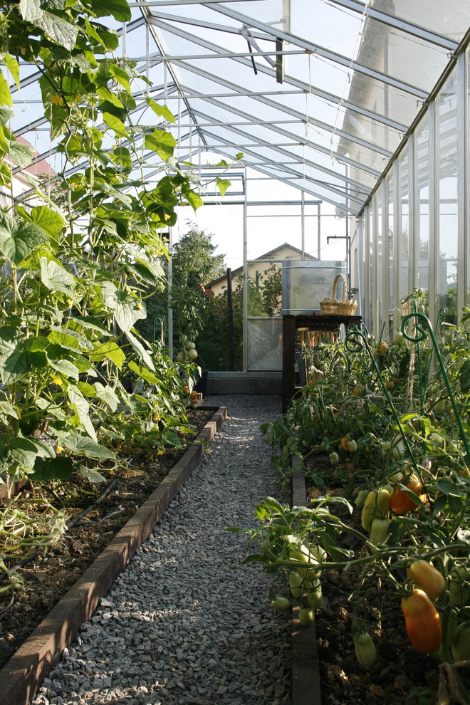 This is an example of a medium sized farmhouse attached greenhouse in Other.