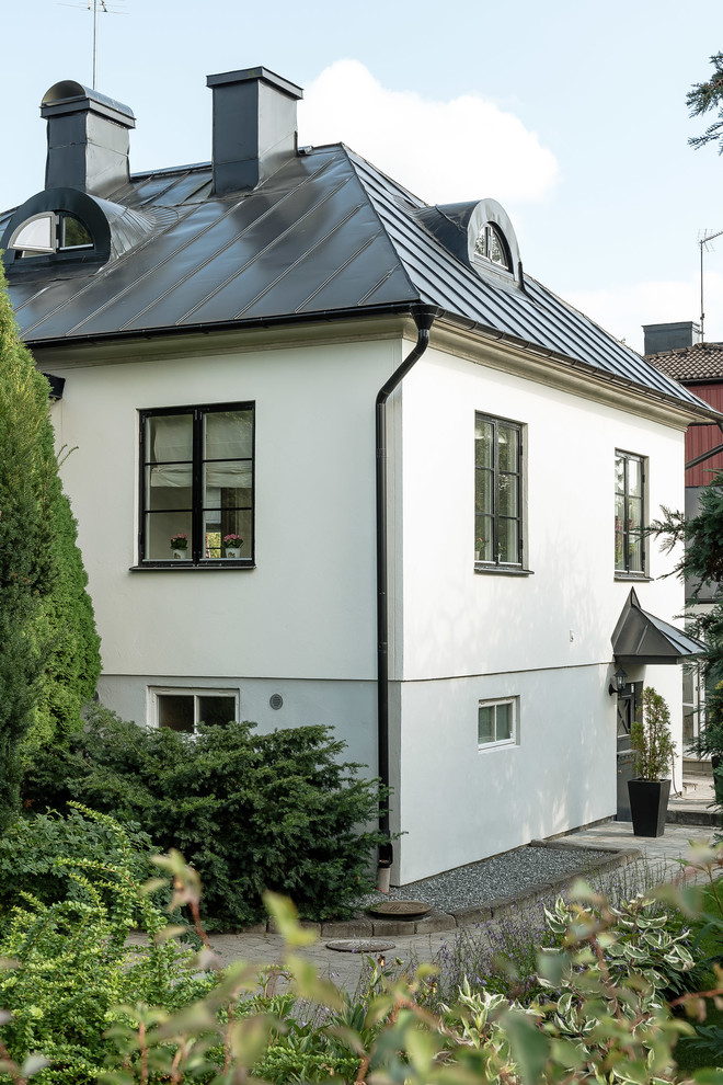 White classic house exterior in Orebro with three floors.