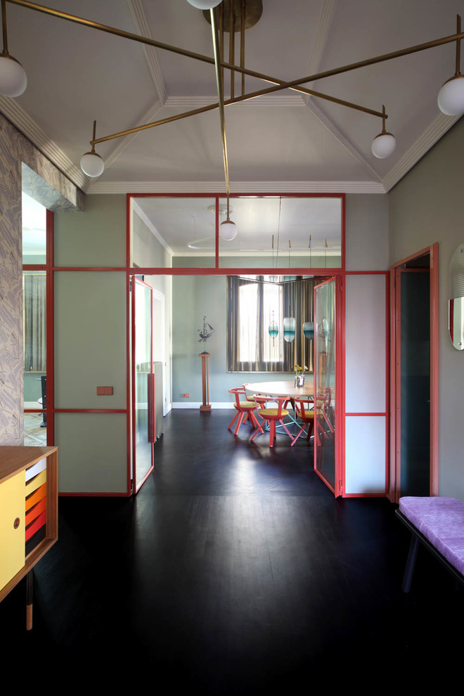Example of an eclectic black floor entryway design in Venice with green walls