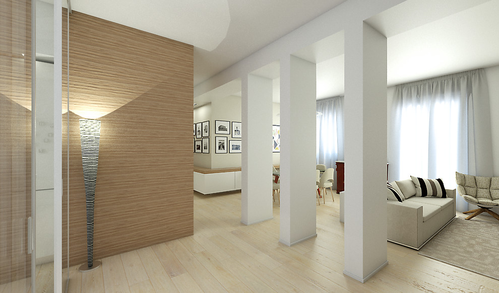 Photo of a medium sized contemporary foyer in Cagliari with light hardwood flooring, white walls and a single front door.