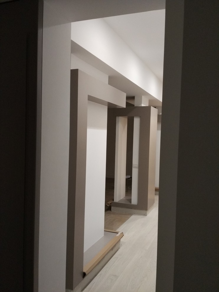 Свежая идея для дизайна: коридор среднего размера в современном стиле с белыми стенами, светлым паркетным полом и белым полом - отличное фото интерьера