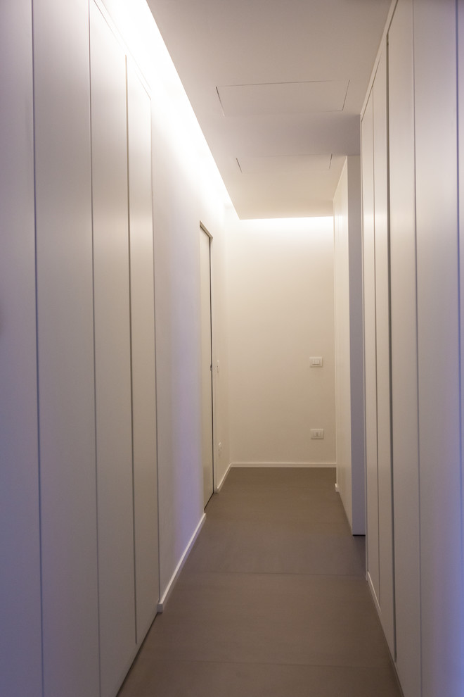 Esempio di un ingresso o corridoio design con pareti bianche e pavimento in gres porcellanato