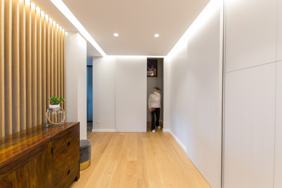 Entryway - contemporary light wood floor entryway idea in Rome with gray walls