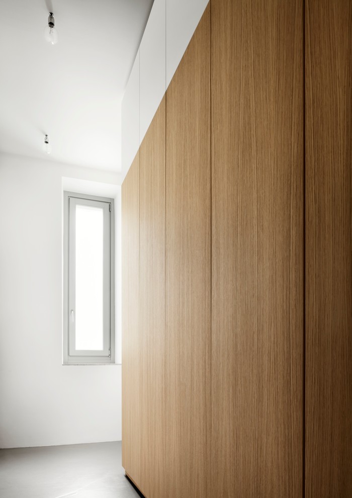 Photo of a medium sized contemporary foyer in Milan with white walls and a double front door.