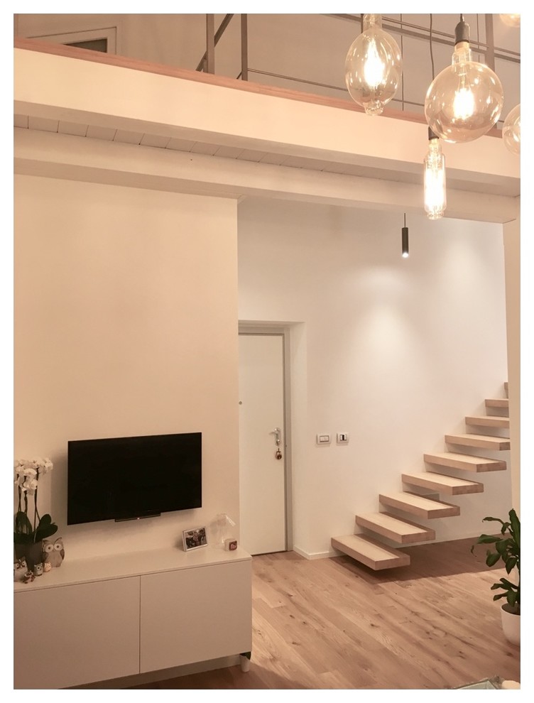 Inspiration for a medium sized contemporary foyer in Turin with white walls, light hardwood flooring, a single front door and a white front door.