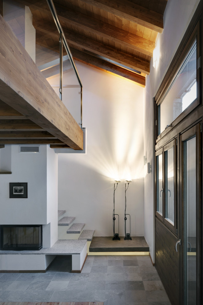 Inspiration for a mid-sized rustic gray floor vestibule remodel in Milan