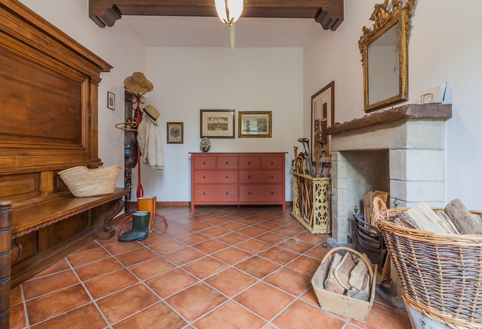 Inspiration for a traditional foyer in Other with white walls, terracotta flooring and red floors.