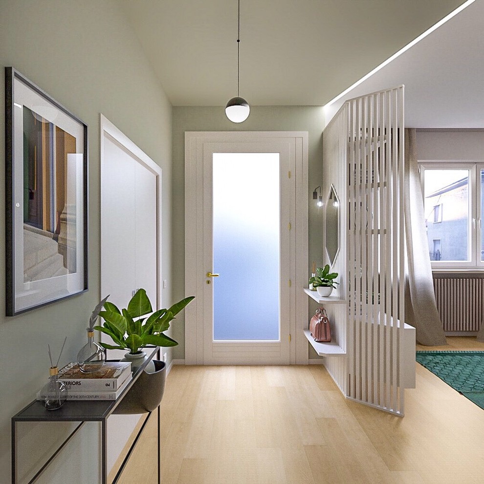 Entryway - mid-sized contemporary light wood floor entryway idea with green walls and a glass front door