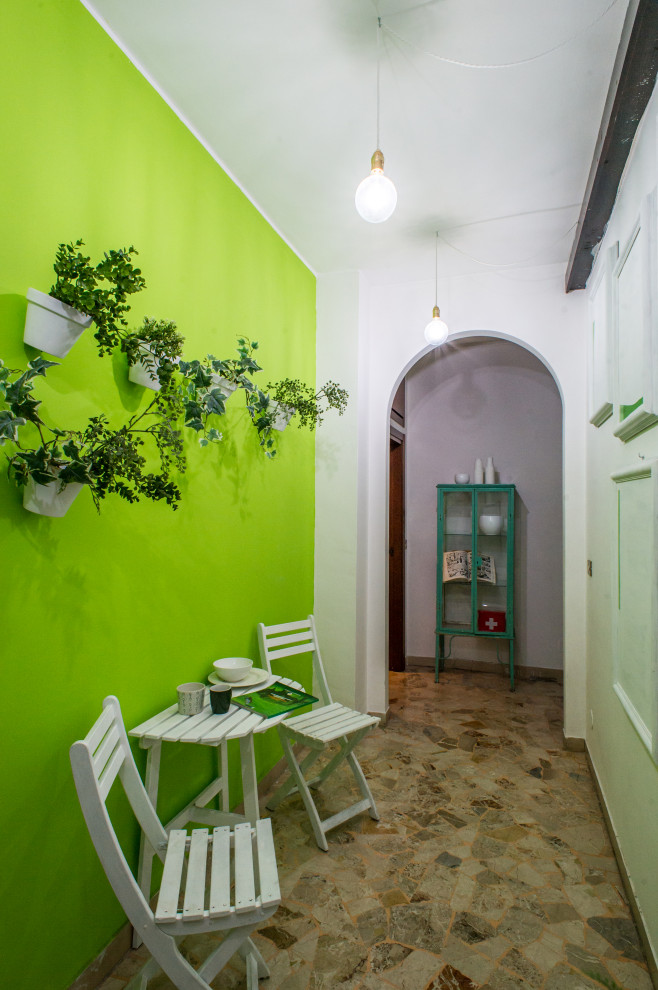 На фото: маленький коридор в стиле фьюжн с зелеными стенами и разноцветным полом для на участке и в саду