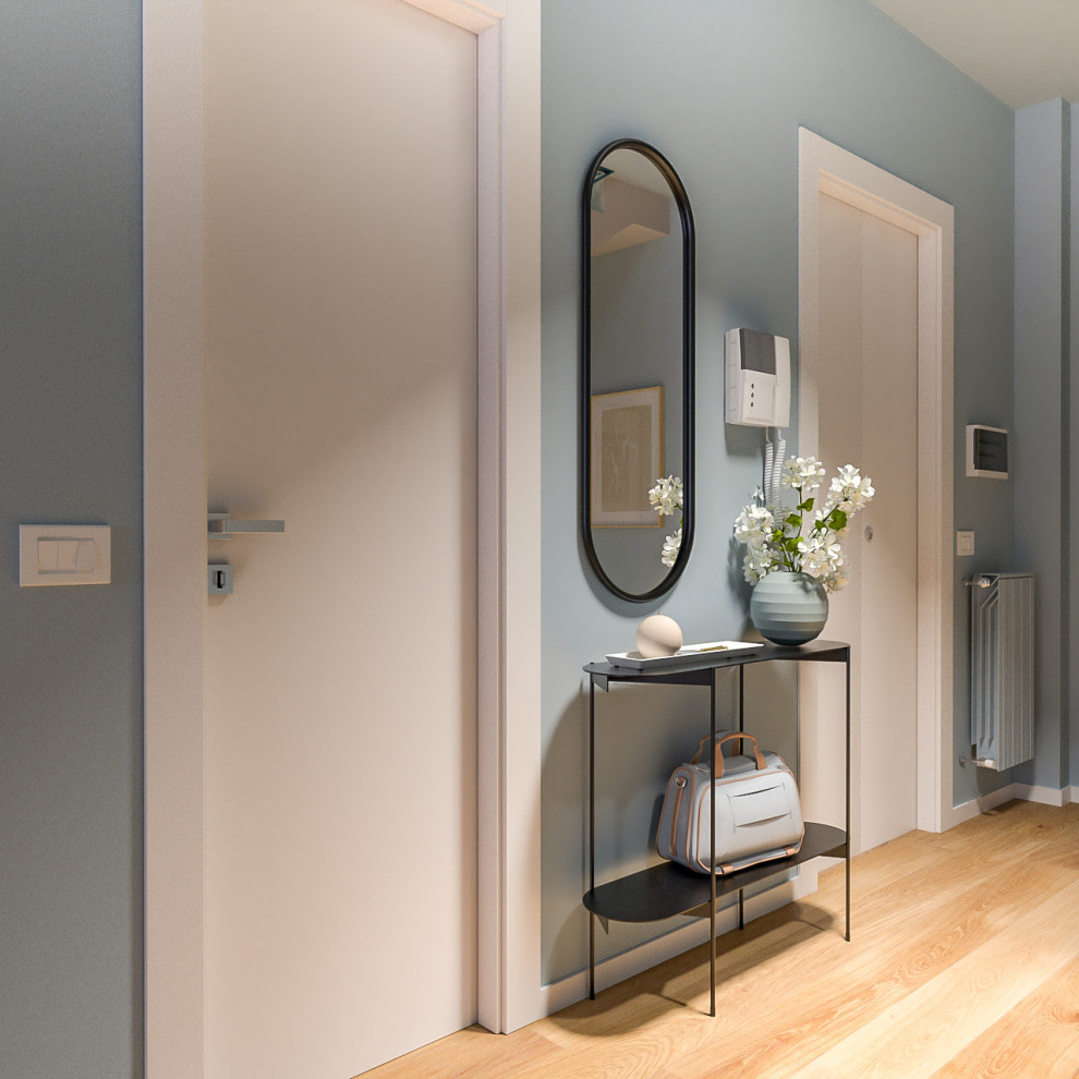 На фото: маленькая узкая прихожая в современном стиле с синими стенами, светлым паркетным полом, одностворчатой входной дверью и белой входной дверью для на участке и в саду