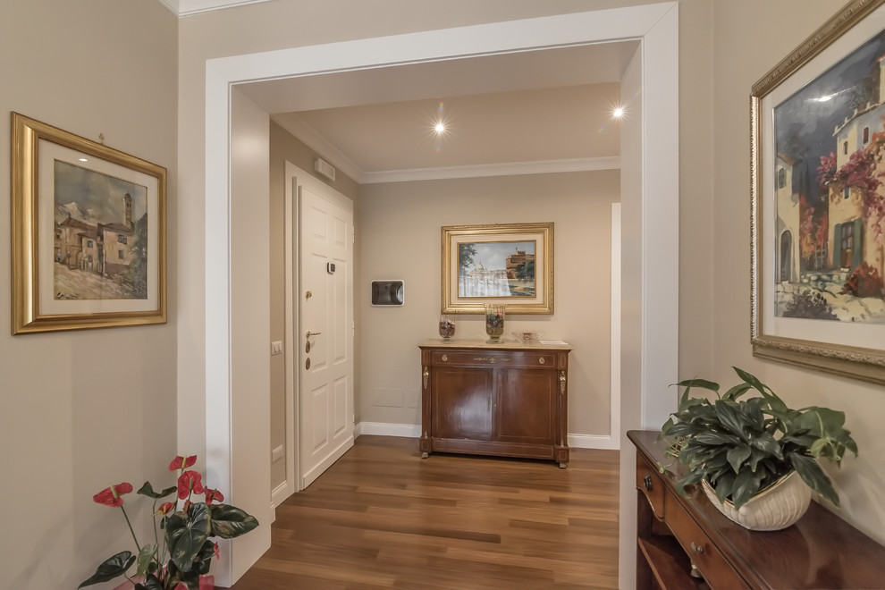 Photo of a classic foyer in Rome with beige walls, medium hardwood flooring, a single front door and a white front door.