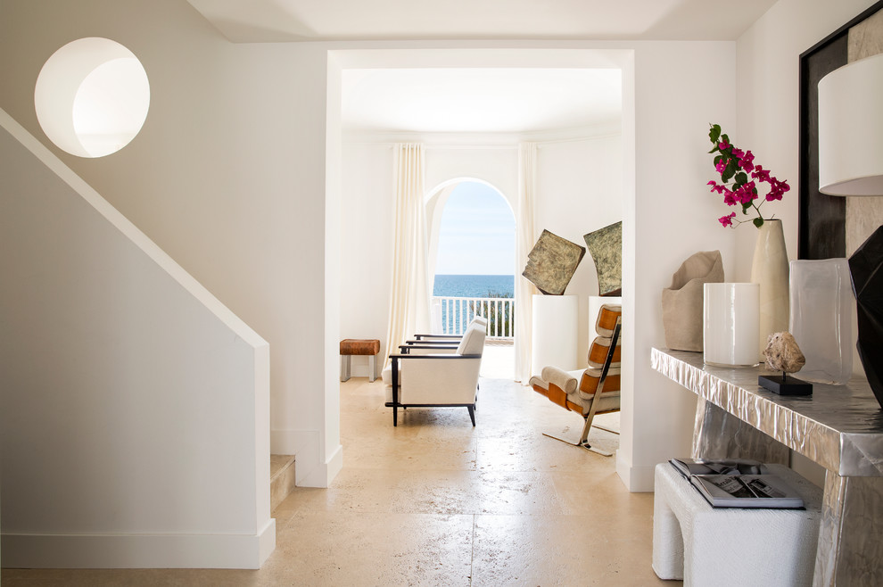 Photo of a medium sized mediterranean entrance in Rome with white walls and white floors.