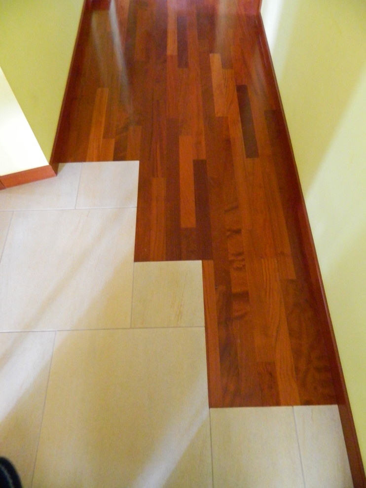 Hallway - small traditional medium tone wood floor and red floor hallway idea in Turin with yellow walls