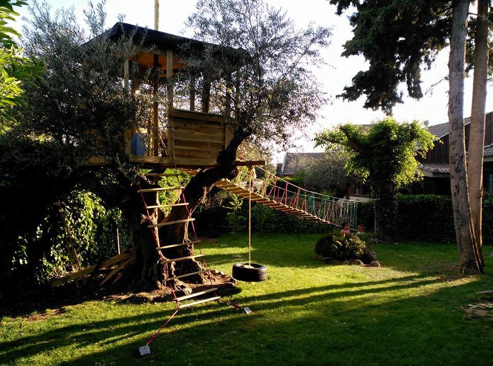 Large farmhouse garden in Madrid with a climbing frame.