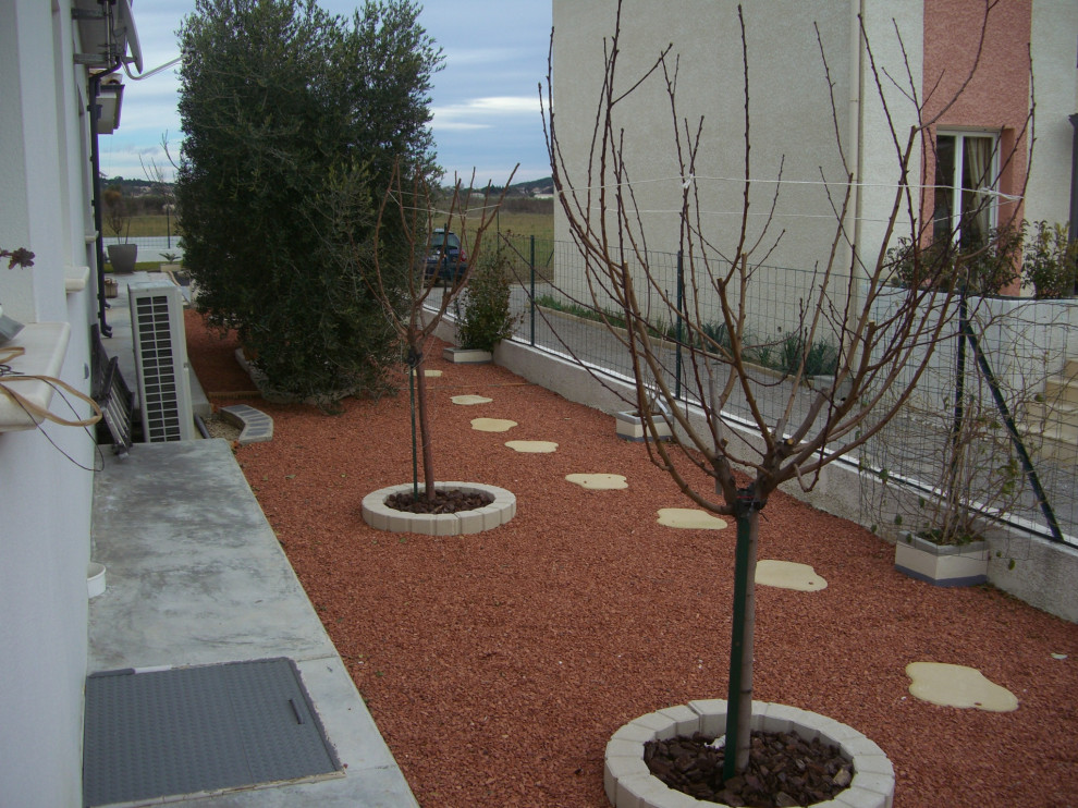 Foto de jardín mediterráneo pequeño en patio lateral con exposición total al sol y gravilla