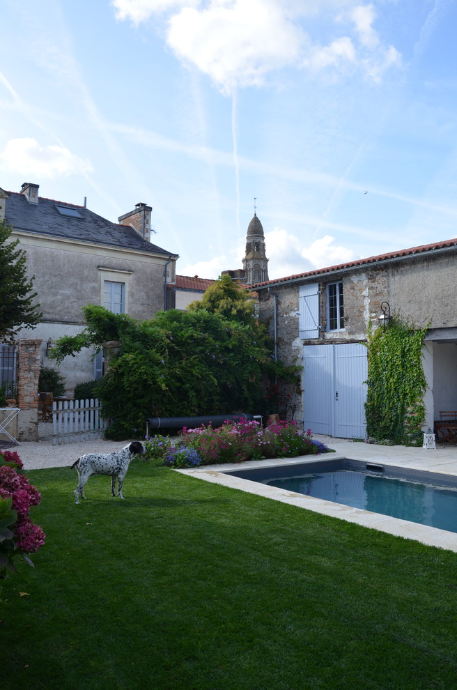 Immagine di un giardino country esposto in pieno sole di medie dimensioni e dietro casa in estate con un focolare e pavimentazioni in pietra naturale