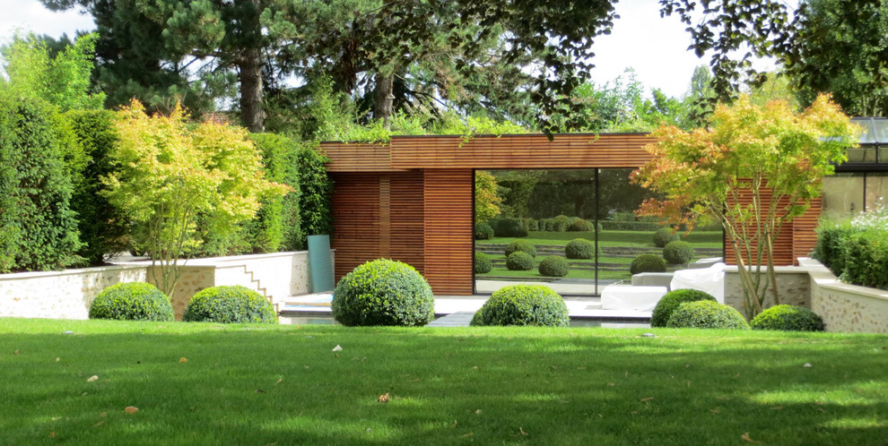 Aménagement d'un grand aménagement d'entrée ou allée de jardin moderne avec une pente, une colline ou un talus et des pavés en pierre naturelle.