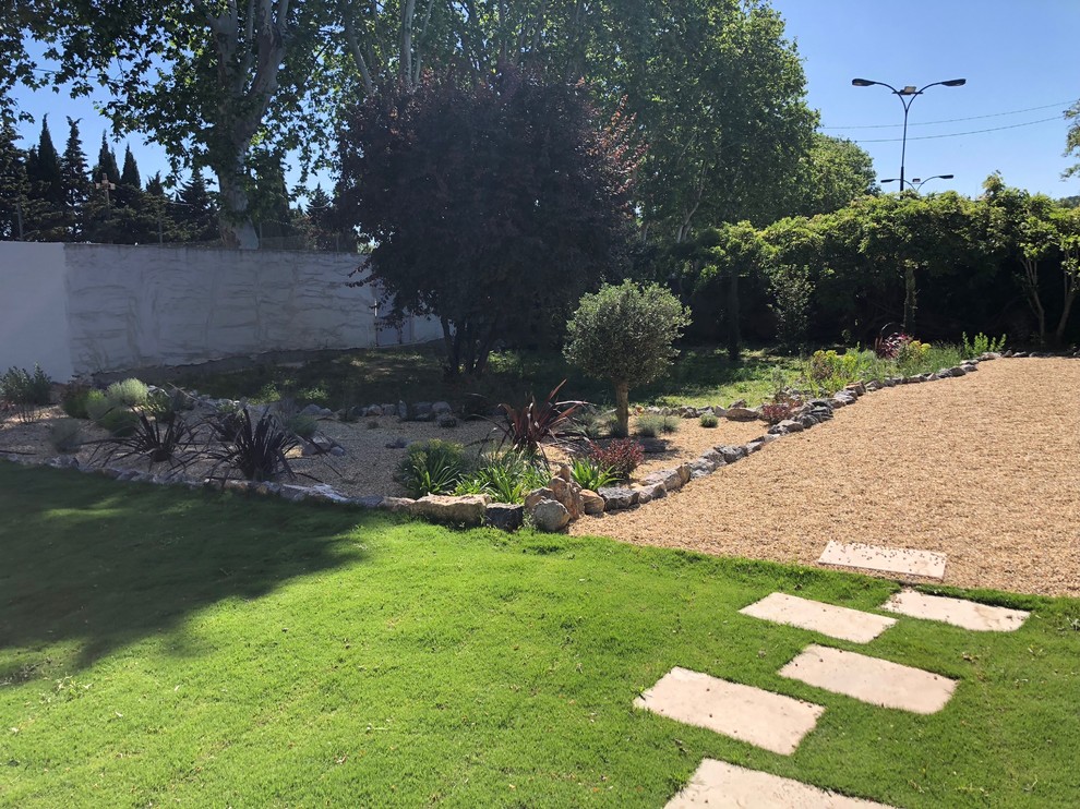 Photo of a large mediterranean backyard landscaping in Toulouse.