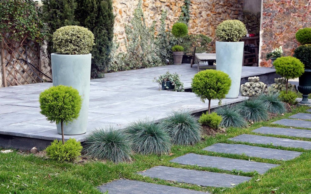 This is an example of a large mediterranean full sun concrete paver landscaping in Paris.