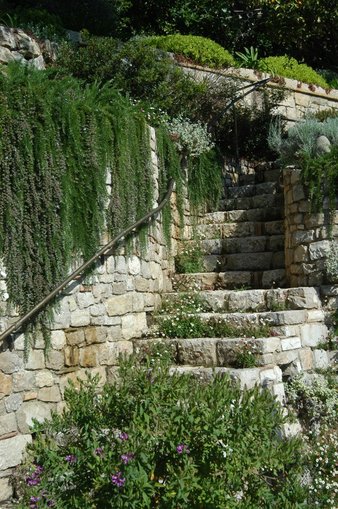This is an example of a mediterranean full sun hillside stone landscaping in Nice.