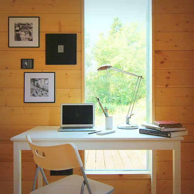 На фото: маленькое рабочее место в скандинавском стиле с деревянным полом и отдельно стоящим рабочим столом для на участке и в саду