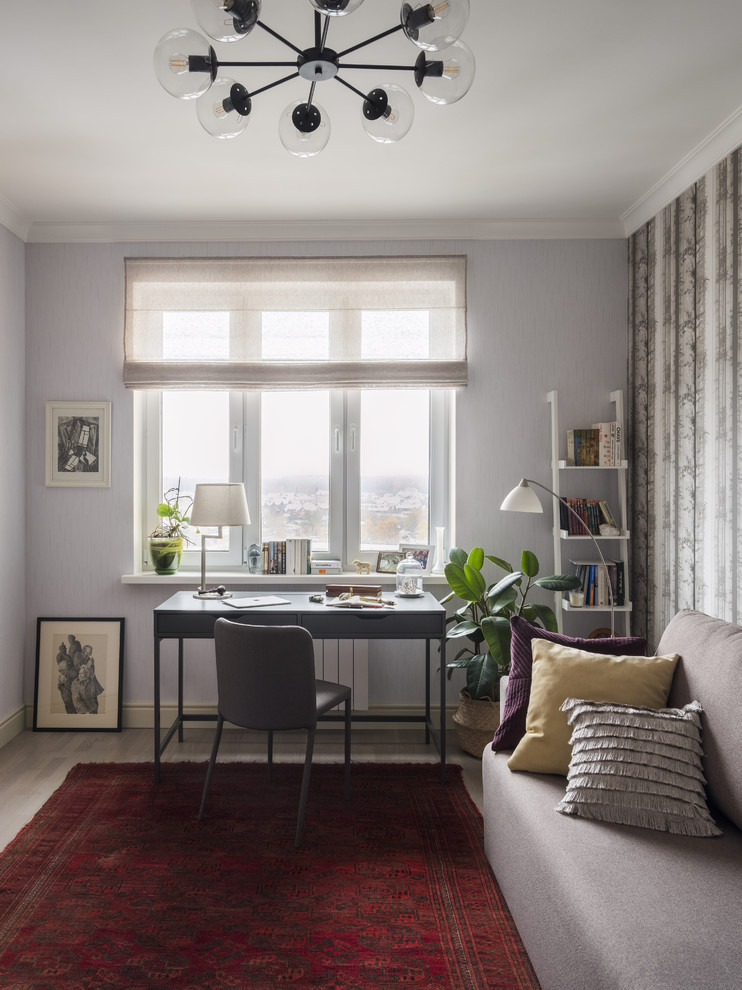 Inspiration for a medium sized classic study in Moscow with grey walls, light hardwood flooring, a freestanding desk, grey floors and no fireplace.