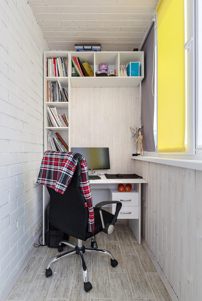 На фото: рабочее место в скандинавском стиле с белыми стенами, отдельно стоящим рабочим столом и бежевым полом