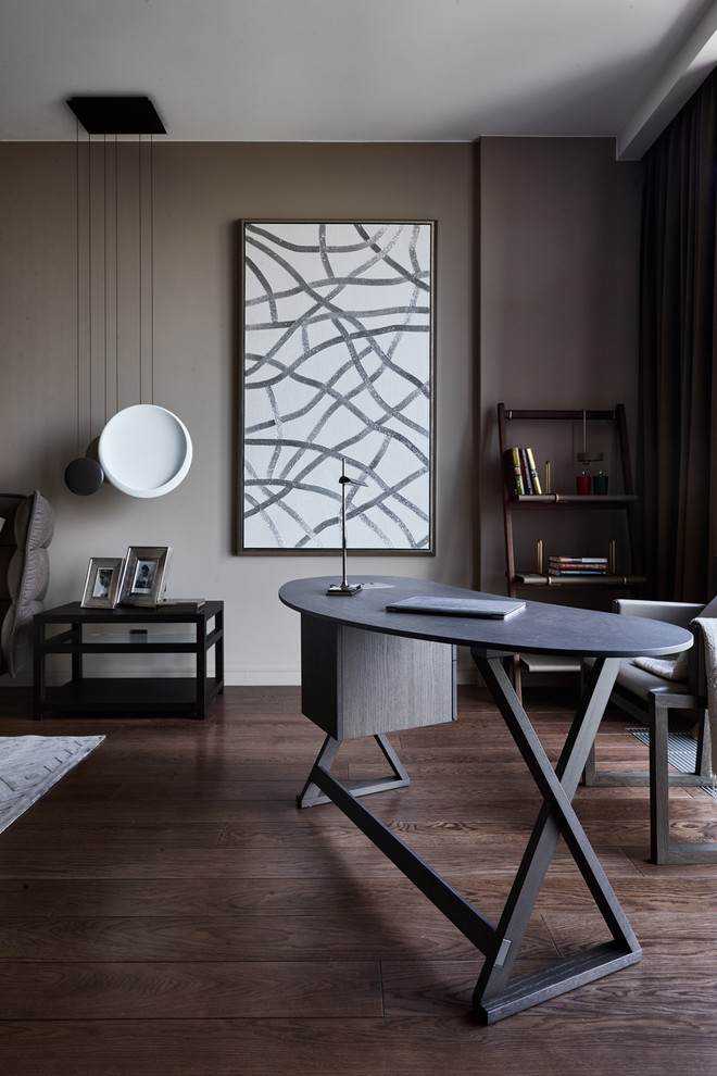 This is an example of a contemporary study in Moscow with brown walls, dark hardwood flooring, a freestanding desk and brown floors.