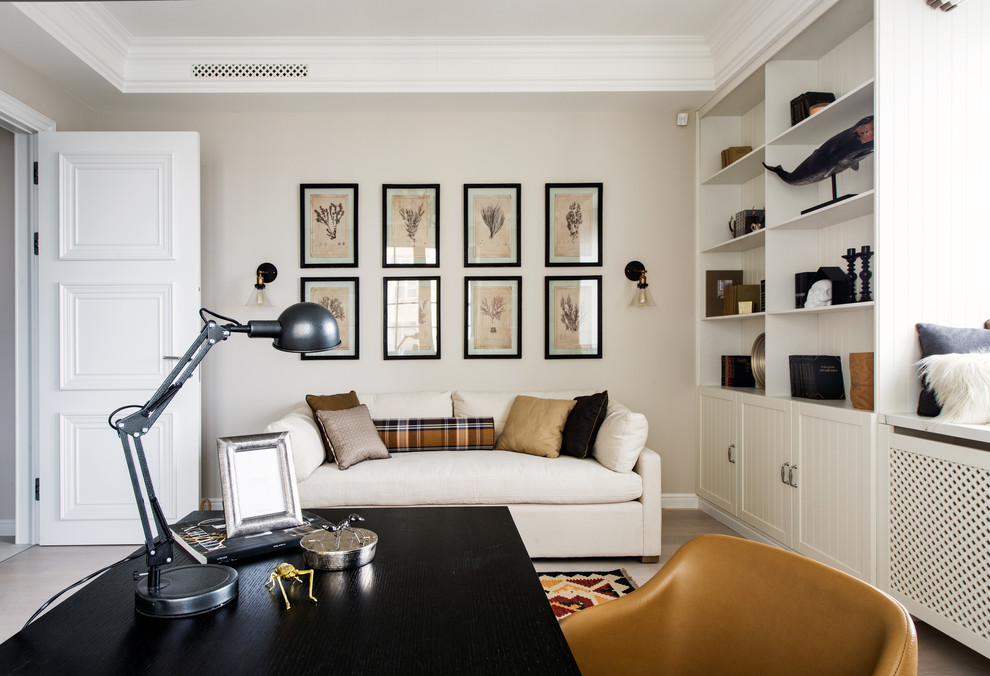 Design ideas for a classic study in Moscow with beige walls, a freestanding desk and light hardwood flooring.