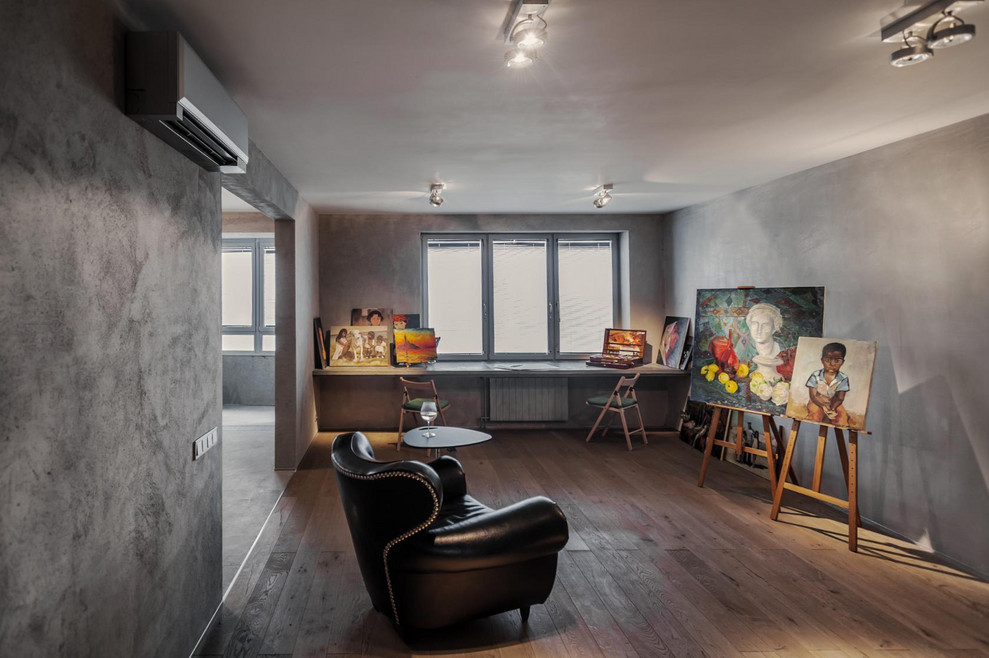 Large contemporary home studio in Moscow with grey walls and a built-in desk.