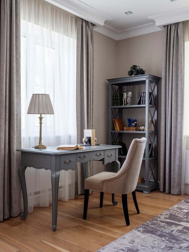 Study room - traditional freestanding desk medium tone wood floor study room idea in Moscow with beige walls