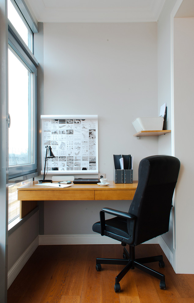 Idee per un piccolo ufficio design con pareti grigie, parquet scuro, scrivania incassata e pavimento marrone