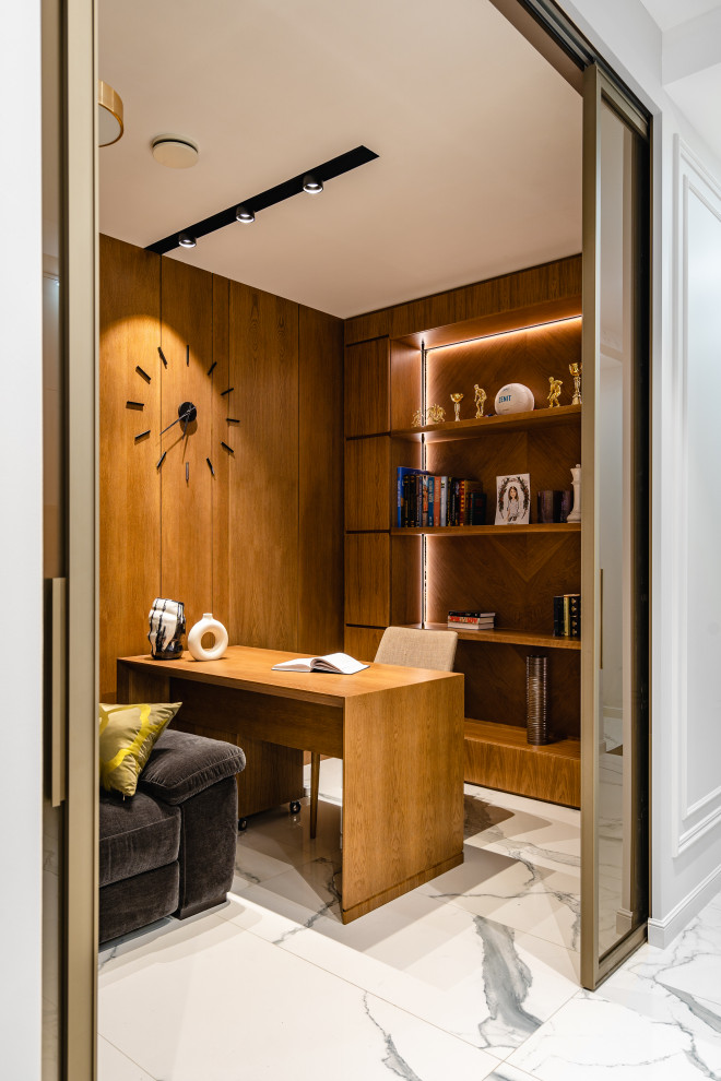 Imagen de despacho contemporáneo de tamaño medio con suelo de baldosas de porcelana y escritorio independiente